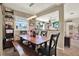 Bright dining area with wood table, bench, chairs, and pass-through to a living space at 1029 Madison St, Largo, FL 33770