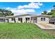 Charming single-story home with a well-manicured lawn and tasteful landscaping at 1029 Madison St, Largo, FL 33770