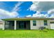 Green backyard showcasing the home's screened lanai and privacy, offering an outdoor retreat at 10621 Scenic Hollow Dr, Riverview, FL 33578