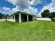 Large backyard with ample space for outdoor activities, features a screened lanai and a white vinyl fence at 10621 Scenic Hollow Dr, Riverview, FL 33578