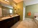 Bathroom showcasing double sinks, granite countertops, tub, and a glass-enclosed shower at 10621 Scenic Hollow Dr, Riverview, FL 33578