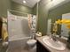 Well-lit bathroom featuring a shower-tub combination and a decorative shower curtain at 10621 Scenic Hollow Dr, Riverview, FL 33578