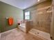 Bright bathroom featuring a soaking tub, a separate glass-enclosed shower, and tile floors at 10621 Scenic Hollow Dr, Riverview, FL 33578