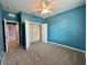 Comfortable bedroom with a standard closet, ceiling fan, and soft carpeting at 10621 Scenic Hollow Dr, Riverview, FL 33578