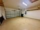 Spacious two-car garage featuring sealed concrete floors, overhead lighting, and plenty of storage at 10621 Scenic Hollow Dr, Riverview, FL 33578