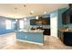 The kitchen has an island with granite countertops, stainless steel appliances, and dark cabinets at 10621 Scenic Hollow Dr, Riverview, FL 33578