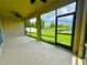 The screened lanai presents panoramic views of the fenced-in yard and a serene pond at 10621 Scenic Hollow Dr, Riverview, FL 33578