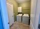 Laundry room with full size washer and dryer at 10621 Scenic Hollow Dr, Riverview, FL 33578
