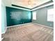 Spacious primary bedroom with tray ceilings, fan, and ample natural light from the two windows at 10621 Scenic Hollow Dr, Riverview, FL 33578