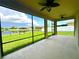 Enjoy serene pond views from the screened-in lanai with ceiling fans, perfect for relaxation and entertaining at 10621 Scenic Hollow Dr, Riverview, FL 33578