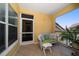 Cozy balcony features a seating area, tile floors, and a view of the surrounding community at 10764 70Th Ave # 4305, Seminole, FL 33772