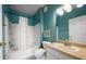 Bright bathroom featuring a shower-tub combo, vanity with sink, and blue walls at 10764 70Th Ave # 4305, Seminole, FL 33772