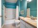 Bright bathroom featuring a shower-tub combo, vanity with sink, and blue walls at 10764 70Th Ave # 4305, Seminole, FL 33772