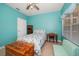 Bright bedroom with nautical themed bedding, turquoise walls, and a ceiling fan at 10764 70Th Ave # 4305, Seminole, FL 33772
