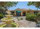 Lush landscaping and an eye-catching fountain in front of this yellow building with awnings and a tile roof at 10764 70Th Ave # 4305, Seminole, FL 33772