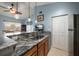 Open kitchen featuring granite countertops, wood cabinets, and stainless steel sink at 10764 70Th Ave # 4305, Seminole, FL 33772