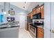 Well-lit kitchen featuring stainless steel appliances, tile floors, and granite countertops at 10764 70Th Ave # 4305, Seminole, FL 33772