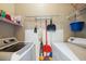 Neat laundry room with washer, dryer, shelving, and cleaning supplies at 10764 70Th Ave # 4305, Seminole, FL 33772