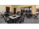 Community patio featuring multiple tables, chairs and umbrellas with tile floors at 10764 70Th Ave # 4305, Seminole, FL 33772