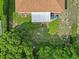 Aerial view of the property showcasing the roof, back patio, and surrounding greenery at 11251 Pickford St, Spring Hill, FL 34609