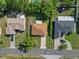 An aerial view shows three single-Gathering homes with well-maintained lawns and driveways at 11251 Pickford St, Spring Hill, FL 34609