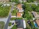 An aerial view of a residential neighborhood shows well-maintained homes and landscaped yards at 11251 Pickford St, Spring Hill, FL 34609