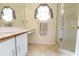 Clean bathroom with glass enclosed shower, tiled floor, and built-in vanity space at 11251 Pickford St, Spring Hill, FL 34609