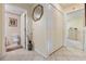 Traditional bathroom featuring tile flooring, a decorative mirror, and hallway access at 11251 Pickford St, Spring Hill, FL 34609
