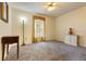Simple bedroom featuring neutral colors, carpet, and a window with gold curtains at 11251 Pickford St, Spring Hill, FL 34609