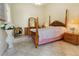 Classic bedroom with a four-poster bed, tile floors, and traditional furnishings at 11251 Pickford St, Spring Hill, FL 34609