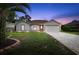 Charming single-story home features a well-manicured lawn, brick-lined driveway, and attached two-car garage at 11251 Pickford St, Spring Hill, FL 34609