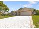 Lovely single-story home with a well-maintained lawn and a long brick-paved driveway at 11251 Pickford St, Spring Hill, FL 34609