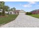 A charming one-story home featuring a two car garage and a brick paved driveway at 11251 Pickford St, Spring Hill, FL 34609