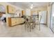 Eat-in kitchen featuring tile floors, and views into the living room and access to an outdoor patio at 11251 Pickford St, Spring Hill, FL 34609