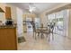 Bright kitchen with light wood cabinets, tiled floor, breakfast table, and a sliding door to the lanai at 11251 Pickford St, Spring Hill, FL 34609