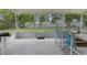 Enclosed patio with table and chairs offering a view of the expansive, well-maintained backyard at 11251 Pickford St, Spring Hill, FL 34609