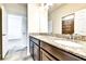 Bathroom with granite countertop, dual sinks, dark cabinets, and tile floor at 11613 Sweet Tangerine Ln, Tampa, FL 33626