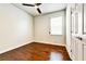 Bright bedroom with hardwood floors, a ceiling fan, and a window with blinds at 11613 Sweet Tangerine Ln, Tampa, FL 33626