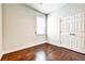 Cozy bedroom with hardwood floors, a double door closet and natural light from the window at 11613 Sweet Tangerine Ln, Tampa, FL 33626