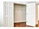 Spacious closet featuring white wooden doors, hanging rod, and wood floors at 11613 Sweet Tangerine Ln, Tampa, FL 33626