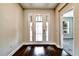 Light-filled entryway with hardwood floors and a view into another room at 11613 Sweet Tangerine Ln, Tampa, FL 33626