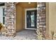 Elegant stone archway frames the front door, enhancing the entryway's appeal at 11613 Sweet Tangerine Ln, Tampa, FL 33626