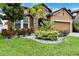 Charming single-Gathering home with well-maintained landscaping, rock beds and a two-car garage at 11613 Sweet Tangerine Ln, Tampa, FL 33626