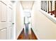 Hallway with wood floors leading to living area and stairway at 11613 Sweet Tangerine Ln, Tampa, FL 33626