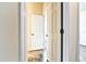 Hallway with tan walls, tile flooring, and white doors at 11613 Sweet Tangerine Ln, Tampa, FL 33626