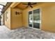 Covered patio with tile flooring, a ceiling fan, and sliding doors for indoor-outdoor living at 11613 Sweet Tangerine Ln, Tampa, FL 33626