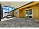 Covered patio featuring tile flooring, a fan, and a cozy fire pit with outdoor seating at 11613 Sweet Tangerine Ln, Tampa, FL 33626