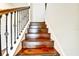 Close up of the staircase showcasing the wood steps and decorative iron railing design at 11613 Sweet Tangerine Ln, Tampa, FL 33626