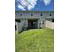 Well-maintained backyard featuring lush green grass, patio, and two-story building at 11634 Woodleaf Dr, Bradenton, FL 34211