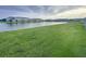Scenic backyard with a pond and lush green grass at 11634 Woodleaf Dr, Bradenton, FL 34211